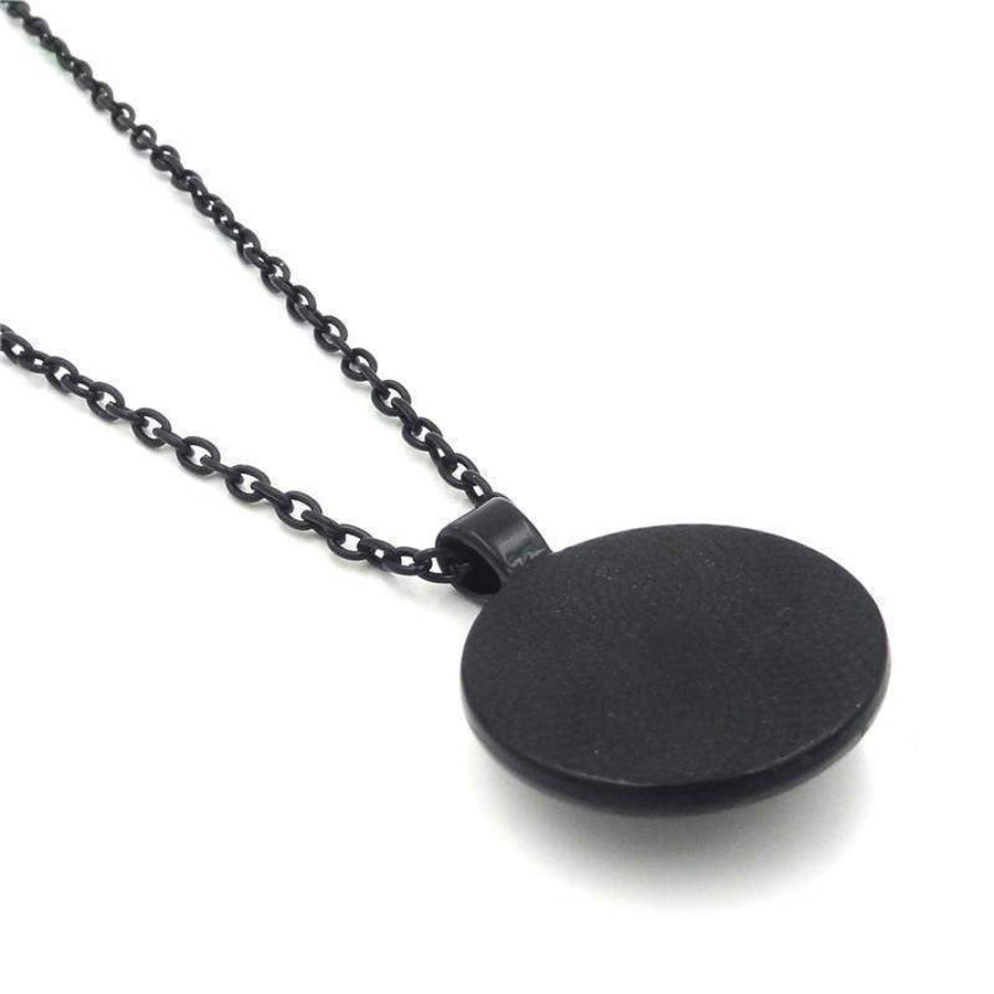 Pendentif cabochon en verre avec yogi et chakras colorés