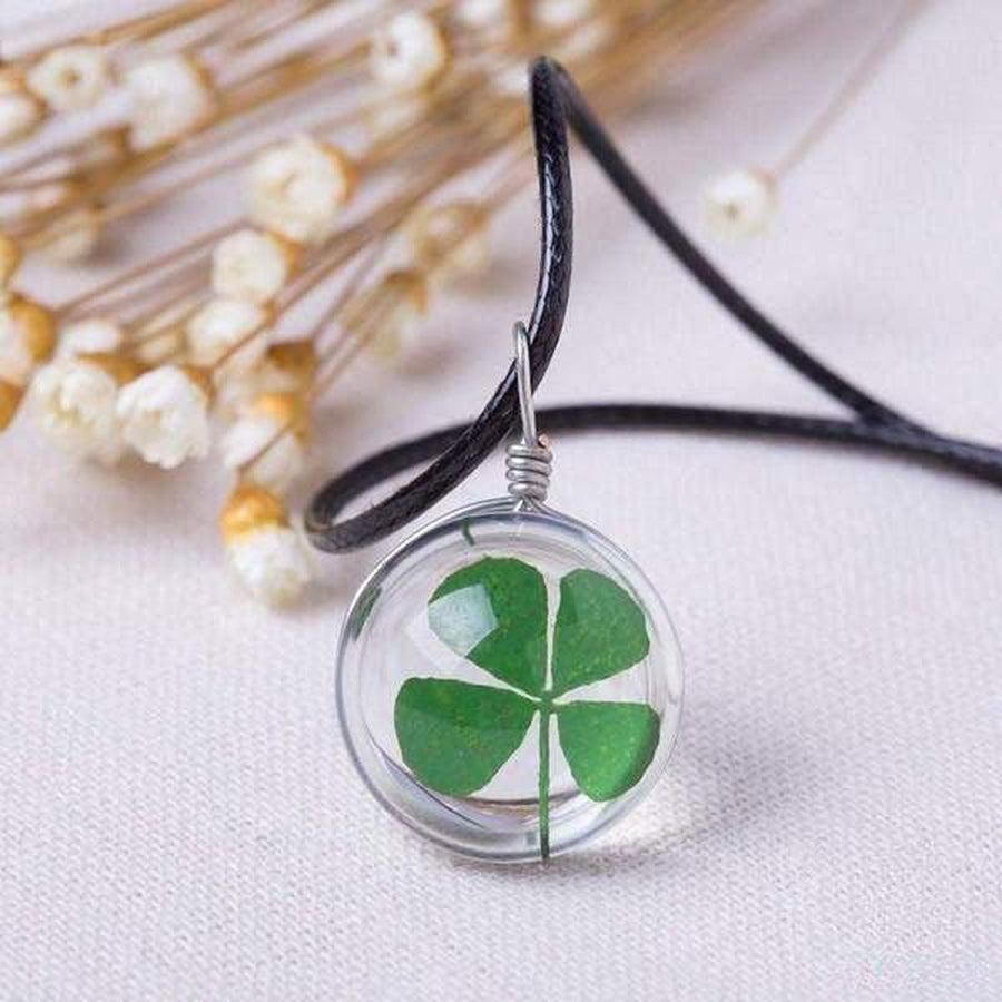 Pendentif élégant avec trèfle séché, sur fond blanc