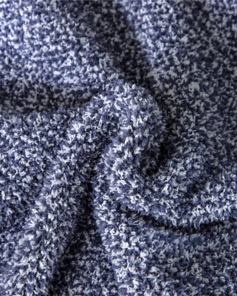 Plaid bleu plié, posé sur une étagère