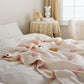 Plaid matelassé rose pâle avec motifs de glace