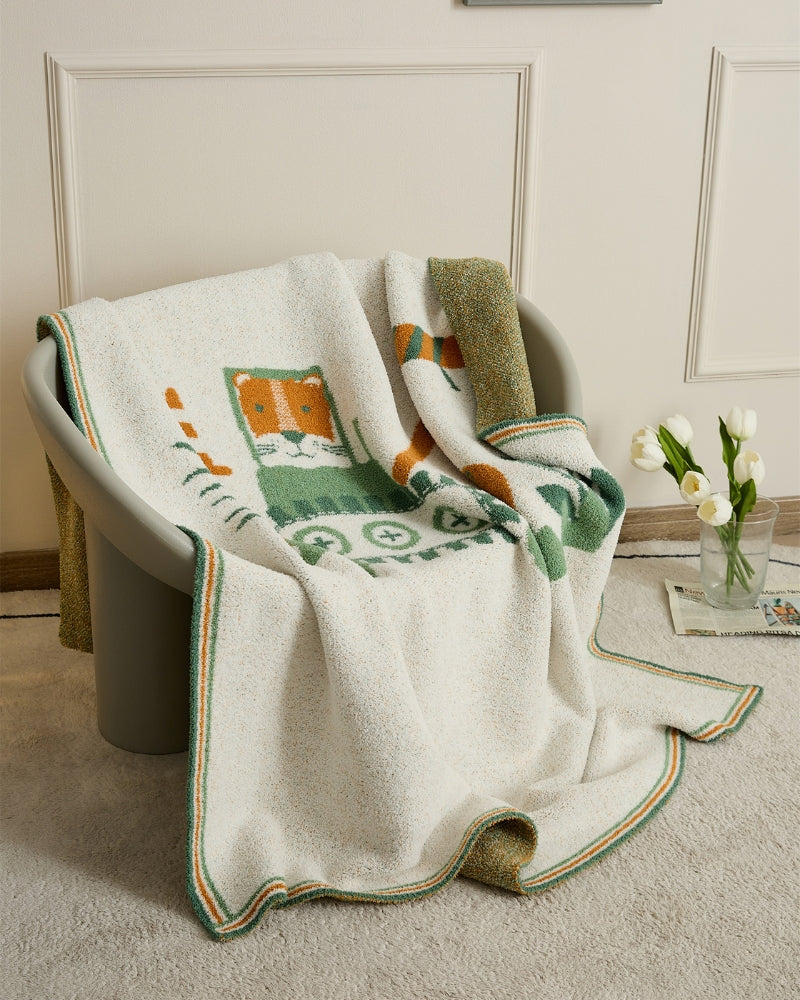 Plaid molletonné crème avec motif animal vert et orange