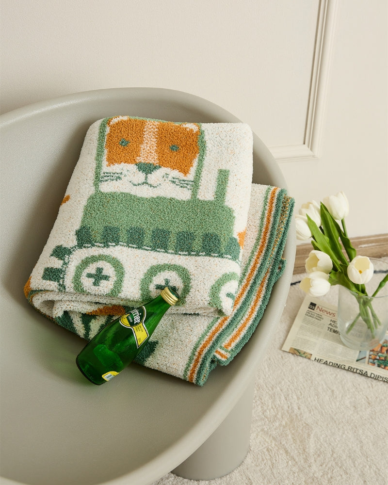 Gros plan sur le motif animal vert du plaid enfant