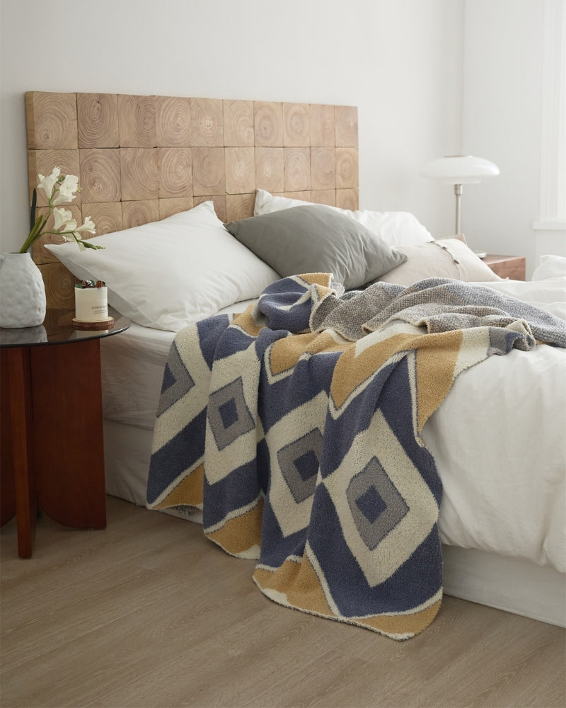 Plaid polaire bleu, camel et crème sur fauteuil
