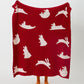 Détail des motifs animaliers blancs sur le plaid rouge