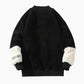 Pull polaire noir avec motif poitrine et manches blanches