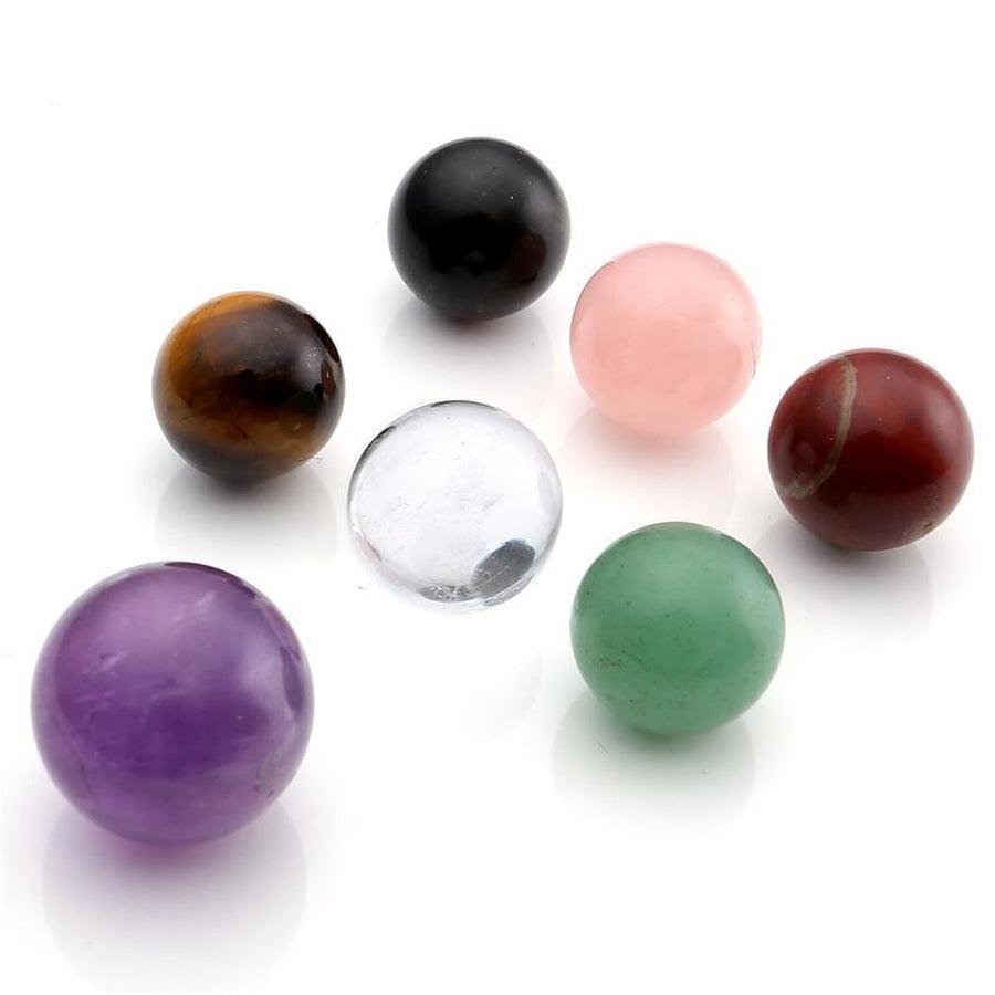 Vue de dessus des sphères 7 chakras sur support en obsidienne noire