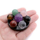 Sphères de chakra colorées posées sur une base noire lisse