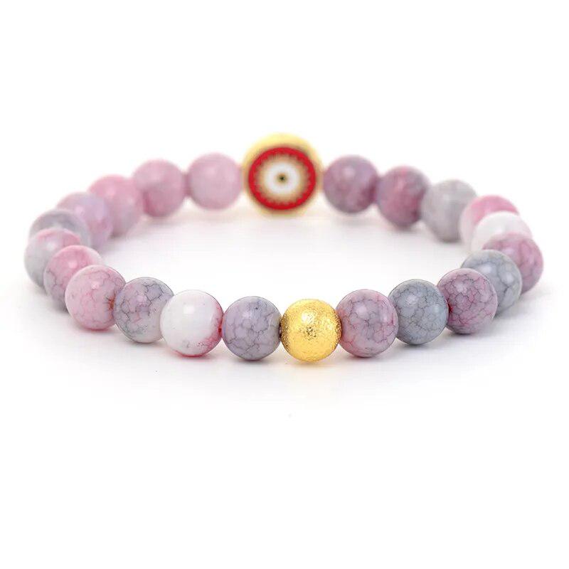 Ensemble mala et bracelet en rhodonite sur fond neutre