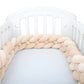 Vue latérale de la tresse beige installée sur un lit