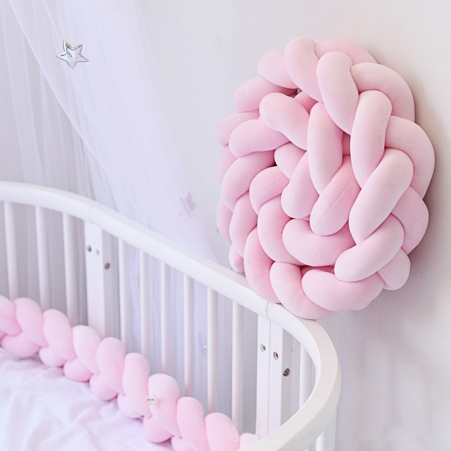 Tresse de lit rose en coton doux sur un lit bébé