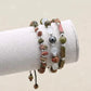 Trio de bracelets en Unakite, Opale et Hématite sur fond blanc