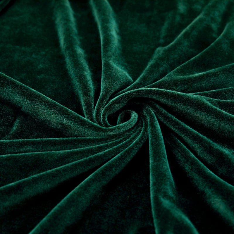 Texture velours vert, brillance subtile sur coussin