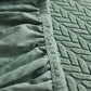 Housse polaire verte enveloppant un coussin, texture moelleuse