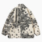Veste en peluche crème avec motifs ethniques et col montant