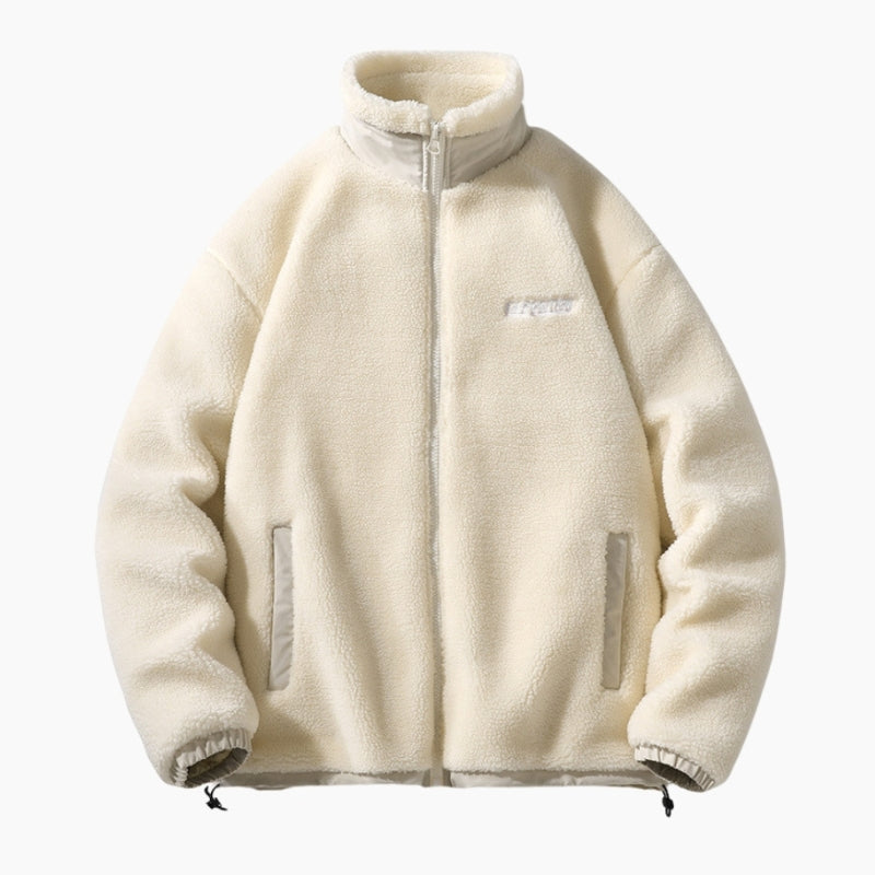 Détail de la veste beige, fermeture éclair et poignets élastiques